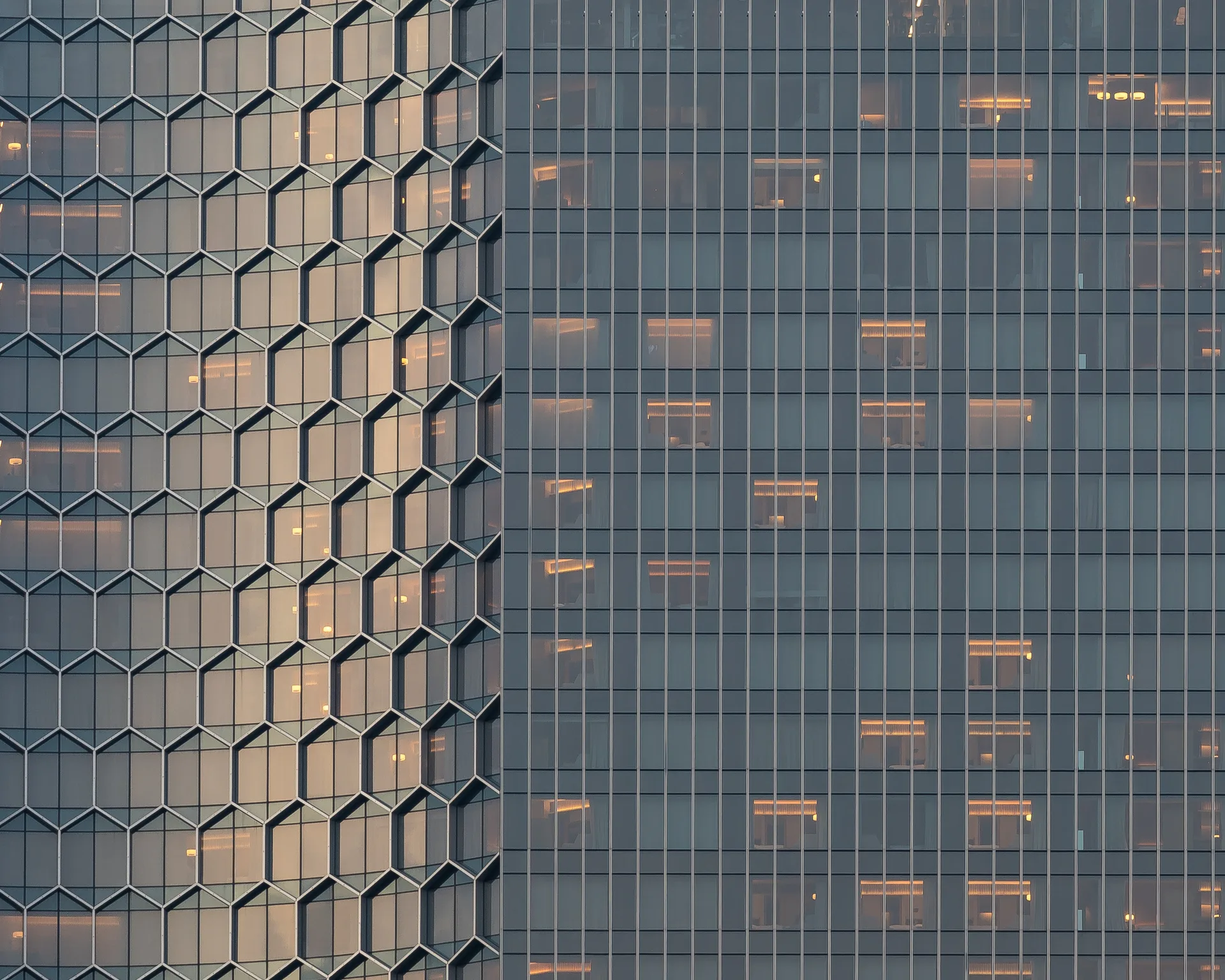 Glass commercial tower facade at dusk